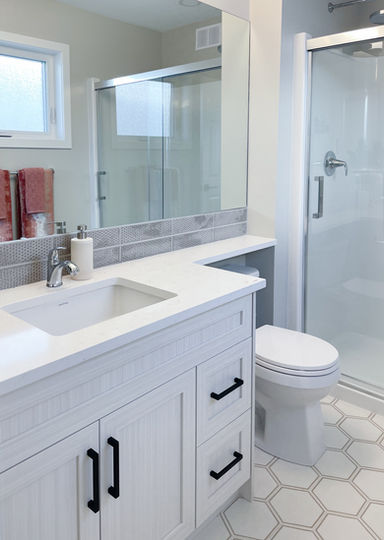 White bathroom vanity with white countertop and black accents 