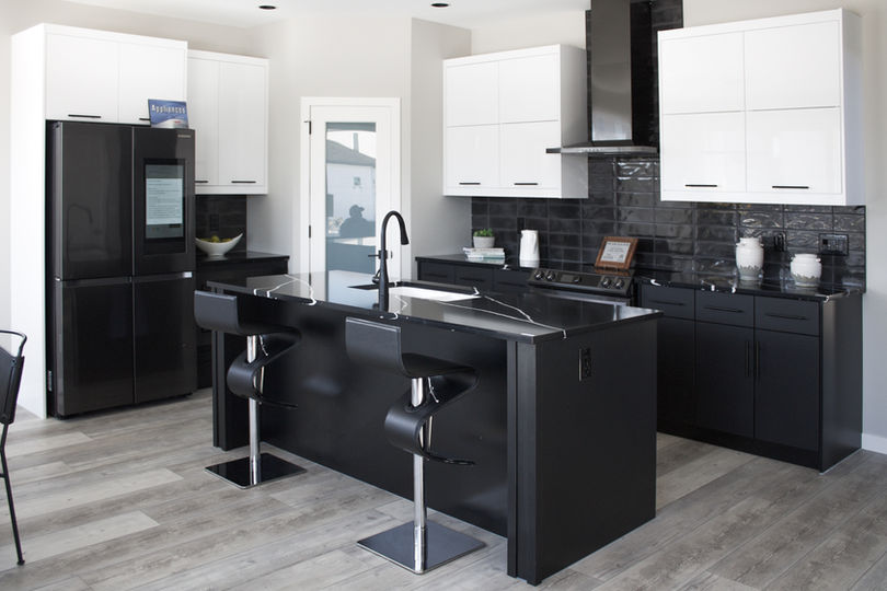 Modern black and white cabinets and trendy marble countertops form a stunning, contemporary kitchen design from Imperial Cabinet in Winnipeg, Manitoba.