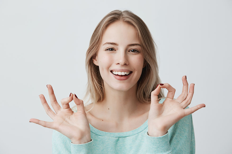 i-m-doing-great-glad-happy-young-blonde-female-blue-sweater-smiling-broadly-making-ok-gest