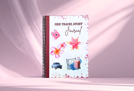 her travel story journal standing tall on a soft pink background