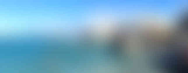 Virgin Gorda beach with huge boulders and turquoise water and people swimming