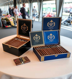 Table with Zeev NY brand Dominican cigars from the collection and black and gold humidors 