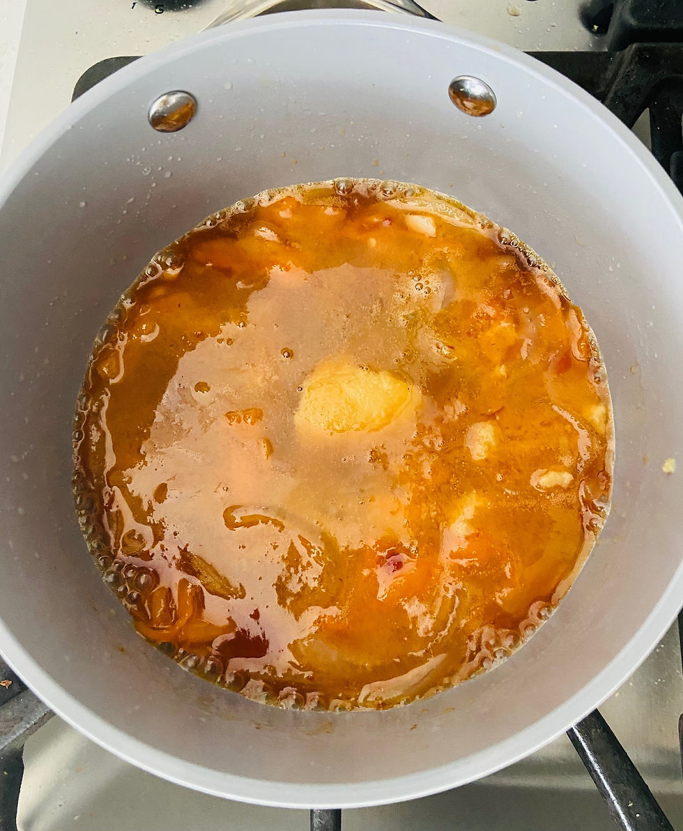 All of the ingredients simmering in a grey sauce pot
