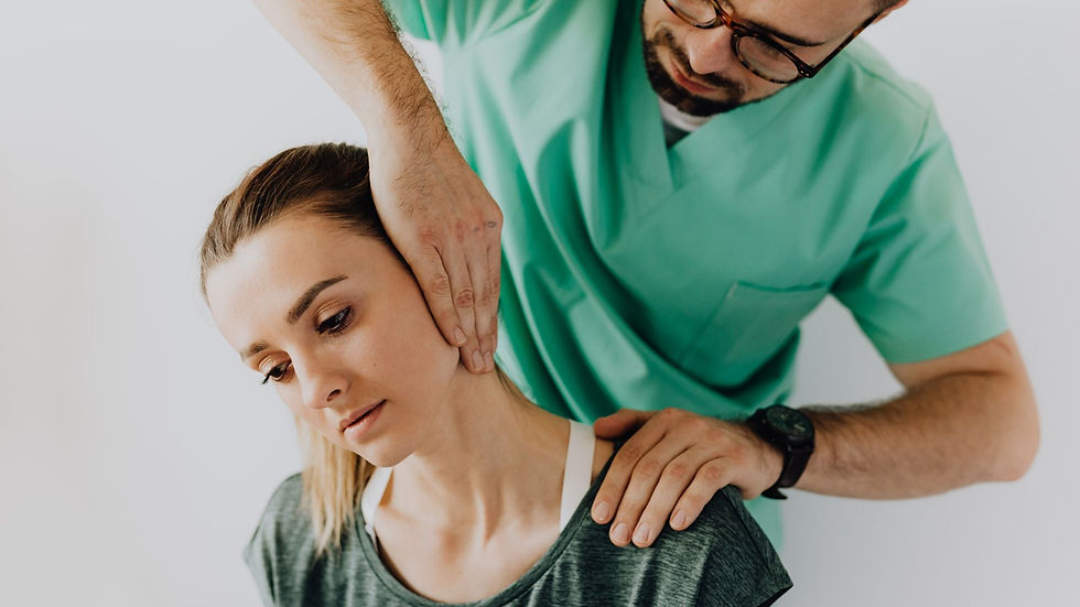 Confident doctor wearing uniform and eyeglasses gently doing therapeutic massage on calm female patients neck and stretching stiff neck muscles