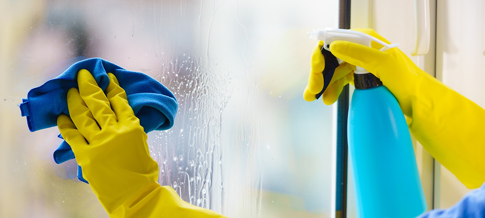 Person Wearing Gloves and Cleaning Window