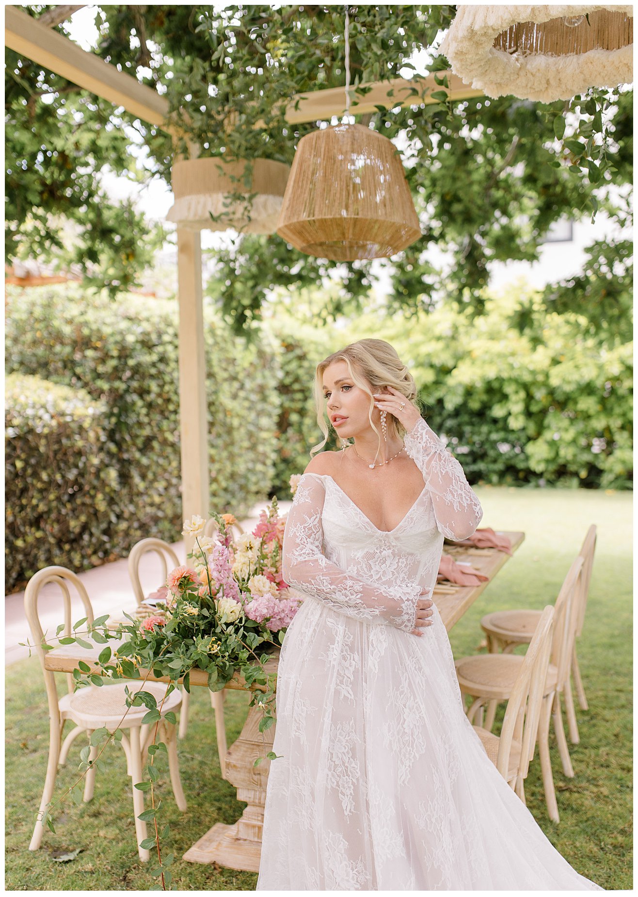 Bride sitting by a tablescape at a wedding