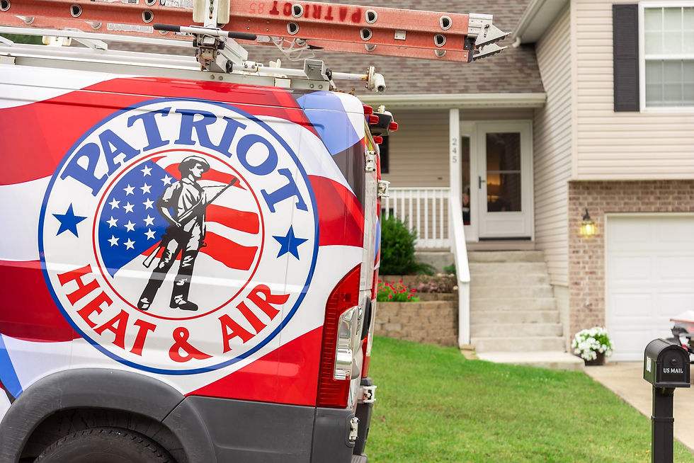 Patriot Heat & Air service van parked in front of a residential home with a technician ladder mounted on top.