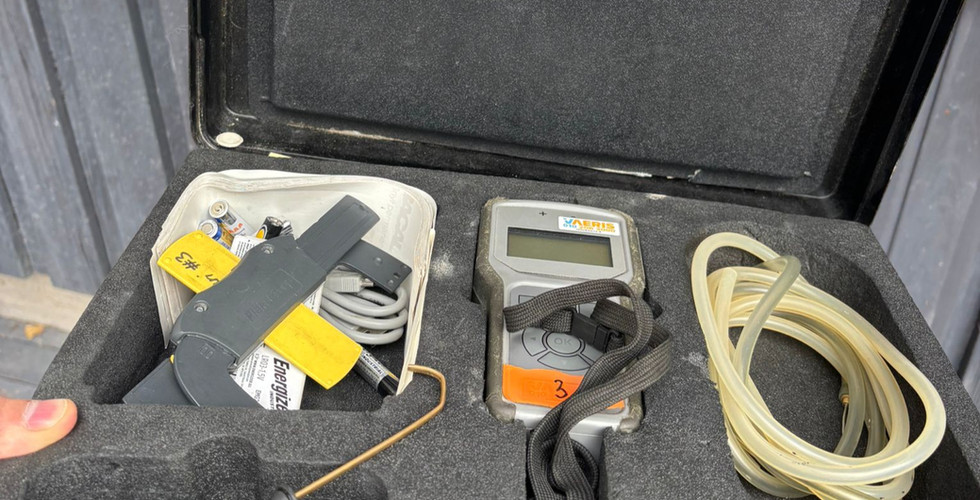 The image shows the Pressovac PHM-V1 valve adjustment meter, hoses, a measuring probe, a feeler gauge, and the meter’s carrying case.