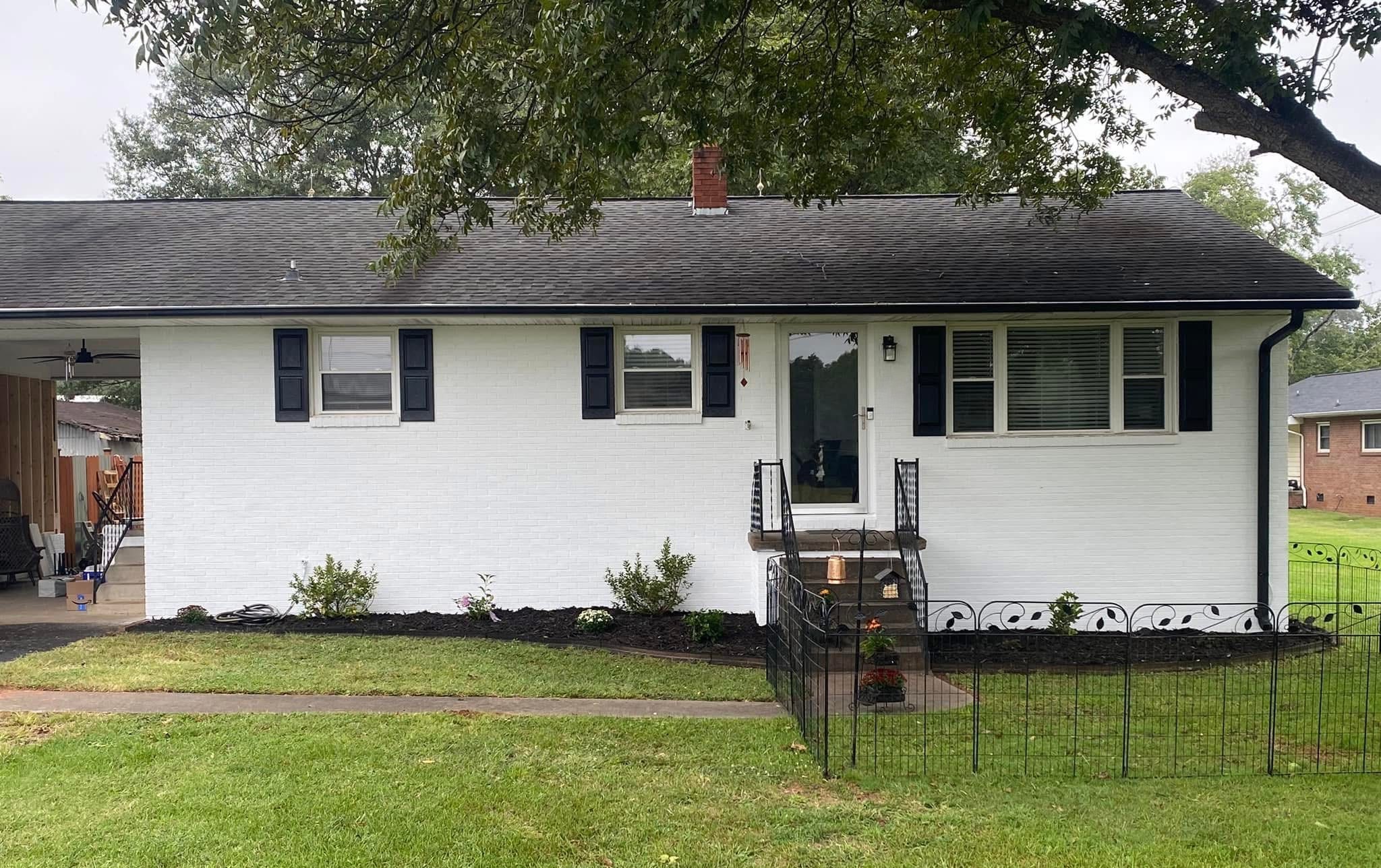 White painted brick exterior with refreshed landscaping