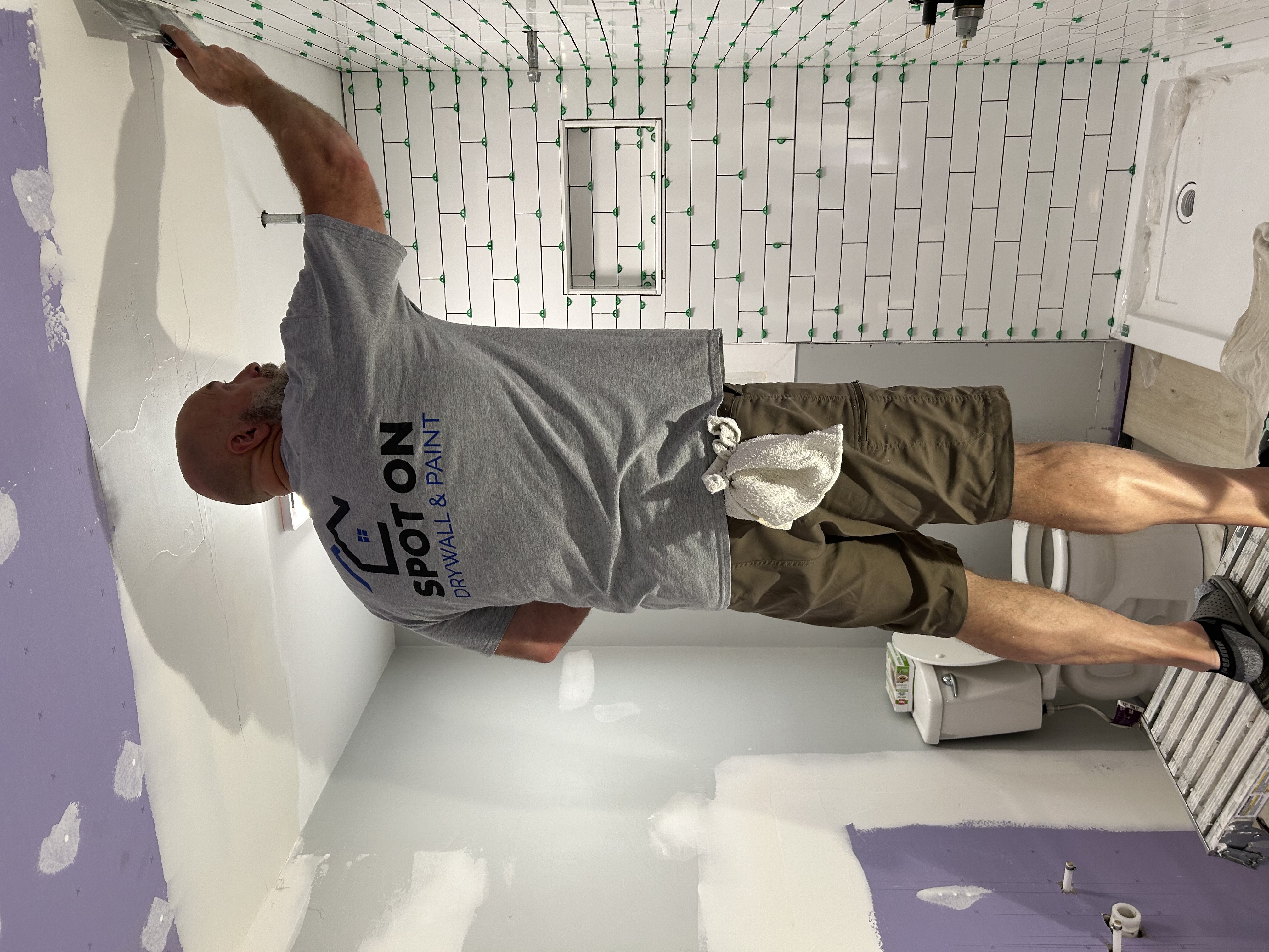 Spot On crew member working on a bathroom renovation