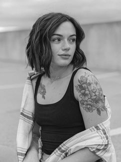 Black and white portrait of female model looking over her shoulder