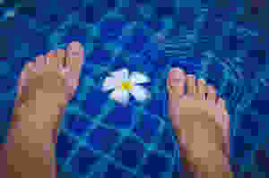 happy feet relaxing in water after reflexology treatment
