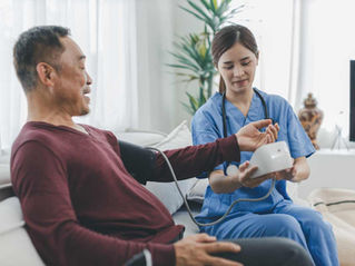 Patient having blood pressure measured by nurse