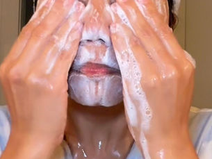 owner cleansing her face