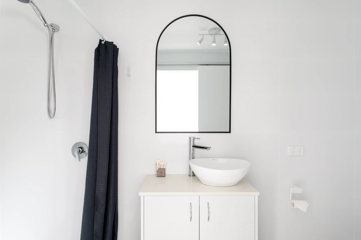 Private ensuite with vessel sink and arch mirror — Burleigh Gold Coast Motel