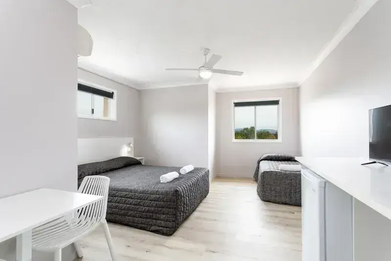 Motel room with microwave, bar fridge, kettle and flat-screen TV at Burleigh Gold Coast Motel.
