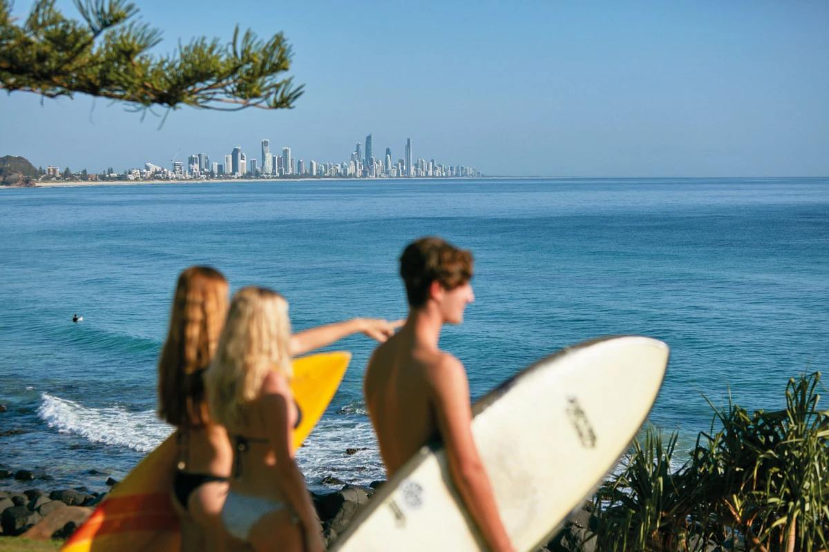 Stand up paddleboarding at Burleigh Heads with Gold Coast skyline — Burleigh Gold Coast Motel