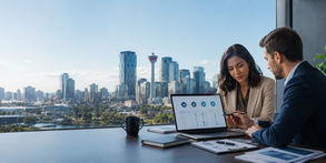 Two business professionals reviewing digital marketing data in an office overlooking Calgary