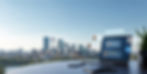 Laptop displaying customer reviews and star ratings with Calgary skyline in the background