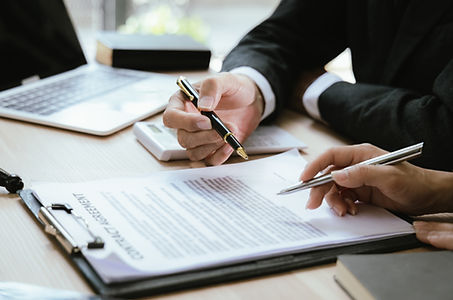 Close up of male lawyer working with contract documents and wooden hammer on table in cour
