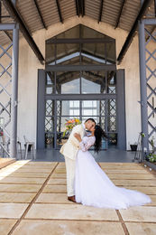couple share kiss at Dove Nest Estate front.
