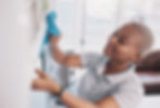 Cleaning, happy and dust with black woman in living rom for housekeeping, hygiene and disi