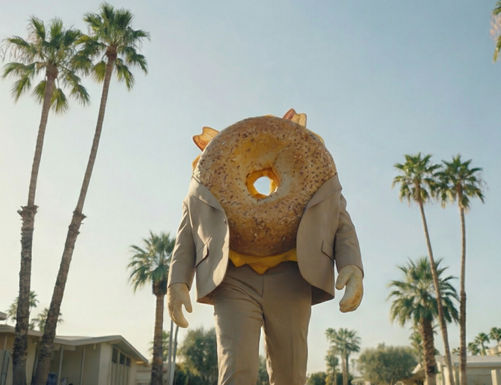 Surreal AI commercial showing a bagel character in a suit