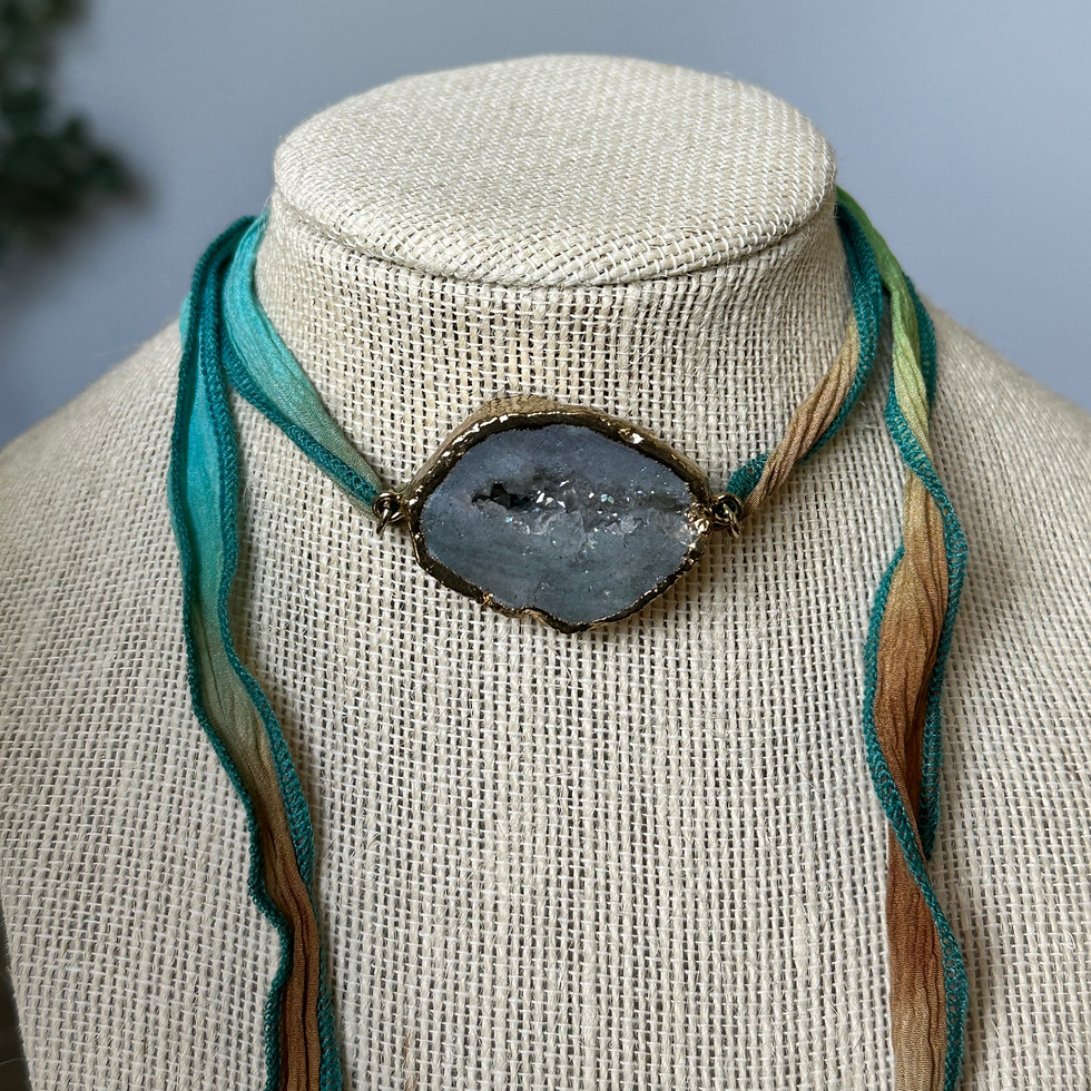 Solstice Geode Necklace - Handcrafted luxury necklace close up shimmering druzy geode centerpiece on hand-spun silk strand