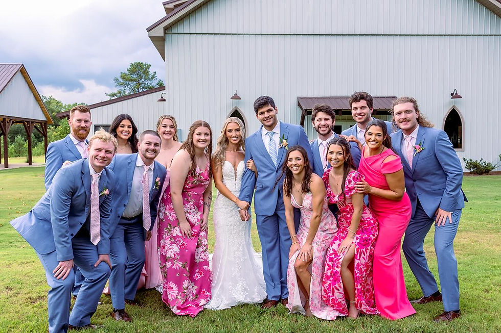 Auburn AL wedding party with bright pink bridesmaids dresses and blue tuxedos