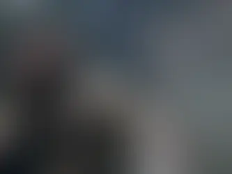 A man holds a blood-stained piece of paper against a mail box