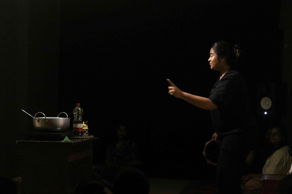 A still from the play, with the audience seated in the round.