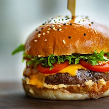 photo-of-juicy-burger-on-wooden-surface-