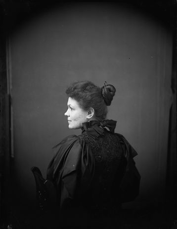 Black & white photograph of a woman sitting in profile