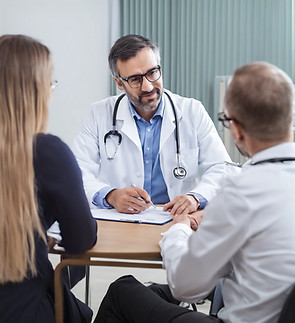friendly doctor answer questions to a patient during a consultation.jpg