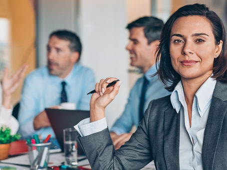 Executive leadership team discussing marketing and sales strategy in a corporate setting.