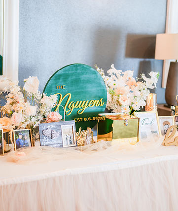 The Nguyens wedding sign with floral decor and photos.