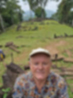 Picture of a man at Javan sacred site Gunung Padang in Indonesia with the first terrace behind him