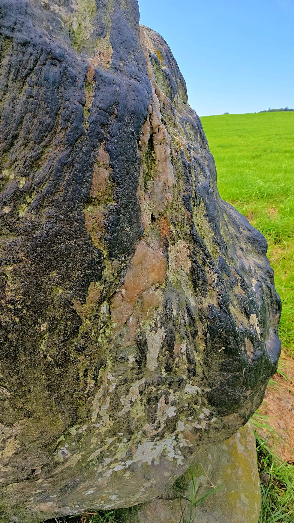A picture of a carved face on a monolith standing stone at Bryn Celli Ddu Anglesey, Wales. Sacred landscapes of the Neolithic and Bronze Ages