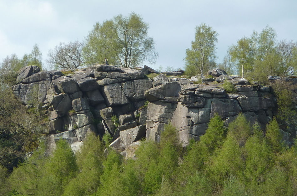 Cratcliffe Rocks gritstone escarpment Derbyshire with woodland below along prehistoric ridge route near Stanton Moor