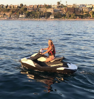 Christy Flesvig, Above Knee Amputee, is seen riding a jetski out on the water for fun.