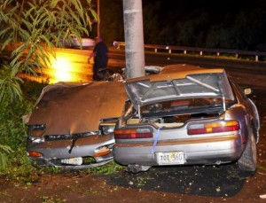 JR's destroyed silver car is seen here. It's off the side of the road in the bushes, and the car is cut completely in half. The car's back half and front half are both facing the camera somehow, and it seems as if there is no way anyone could have survived in that crash.