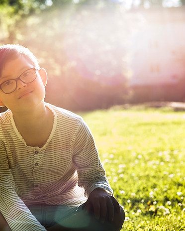 Boy Sitting on Grass