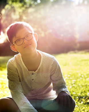 Boy Sitting on Grass