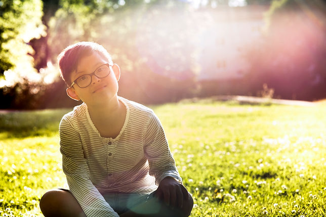 Boy Sitting on Grass