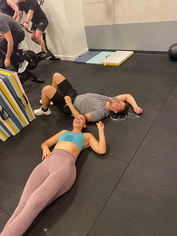 crossfitters-exhausted-after-workout-at-the-workshop-crossfit