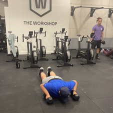 Gym-member-doing-double-dumbbell-devils-press-at-the-workshop-crossfit