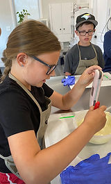 Kids tempering chocolate at a Chok party