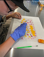 kids use tempered and coloured cocoa butter to create designs for their chocolate bark