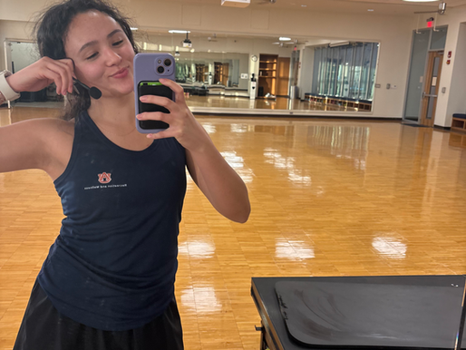 GroupFit instructor posing in the mirror before a class.