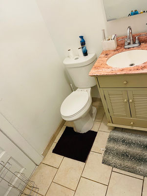 Clean bathroom with toilet, sink, and rug Stephany Clening Services